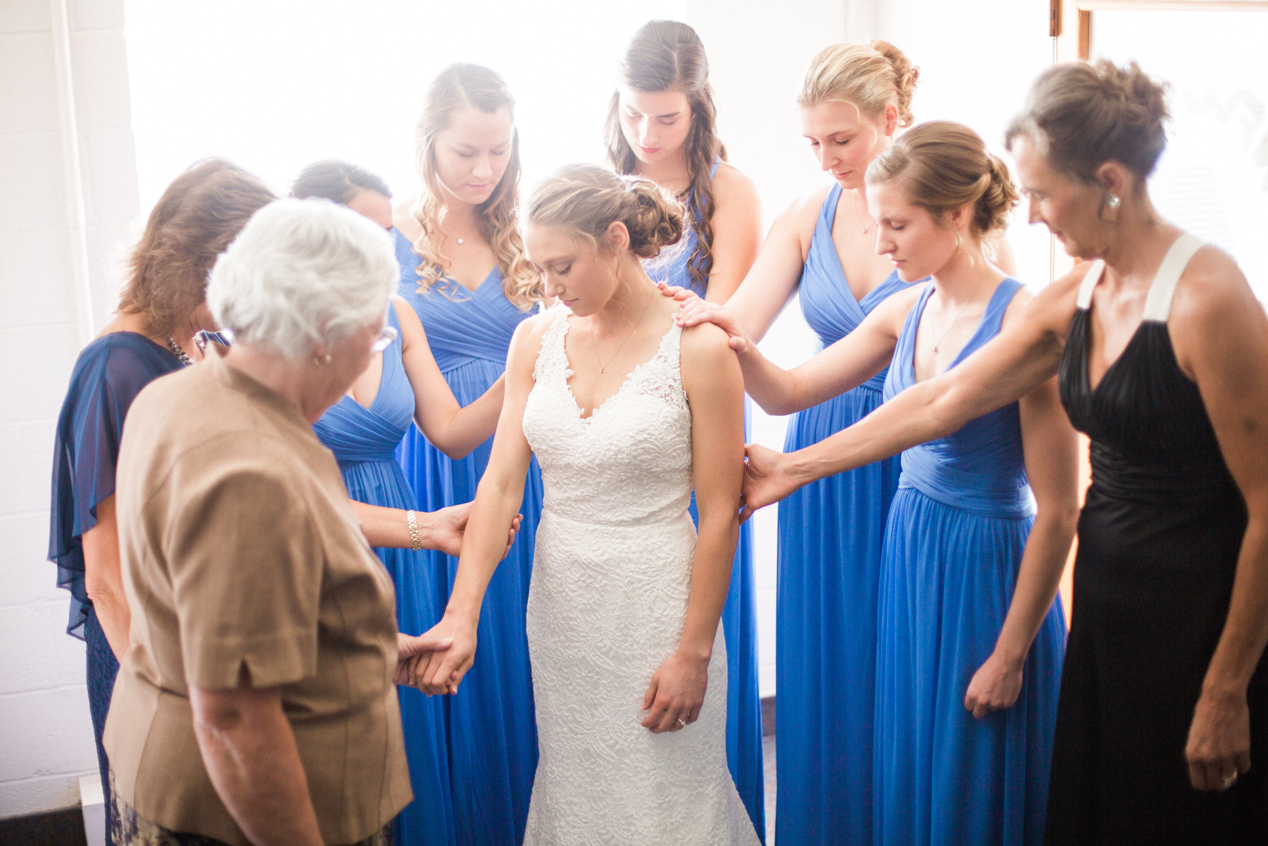 prayer circle around bride before wedding