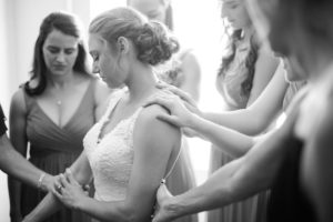 bride and bridesmaids praying before wedding