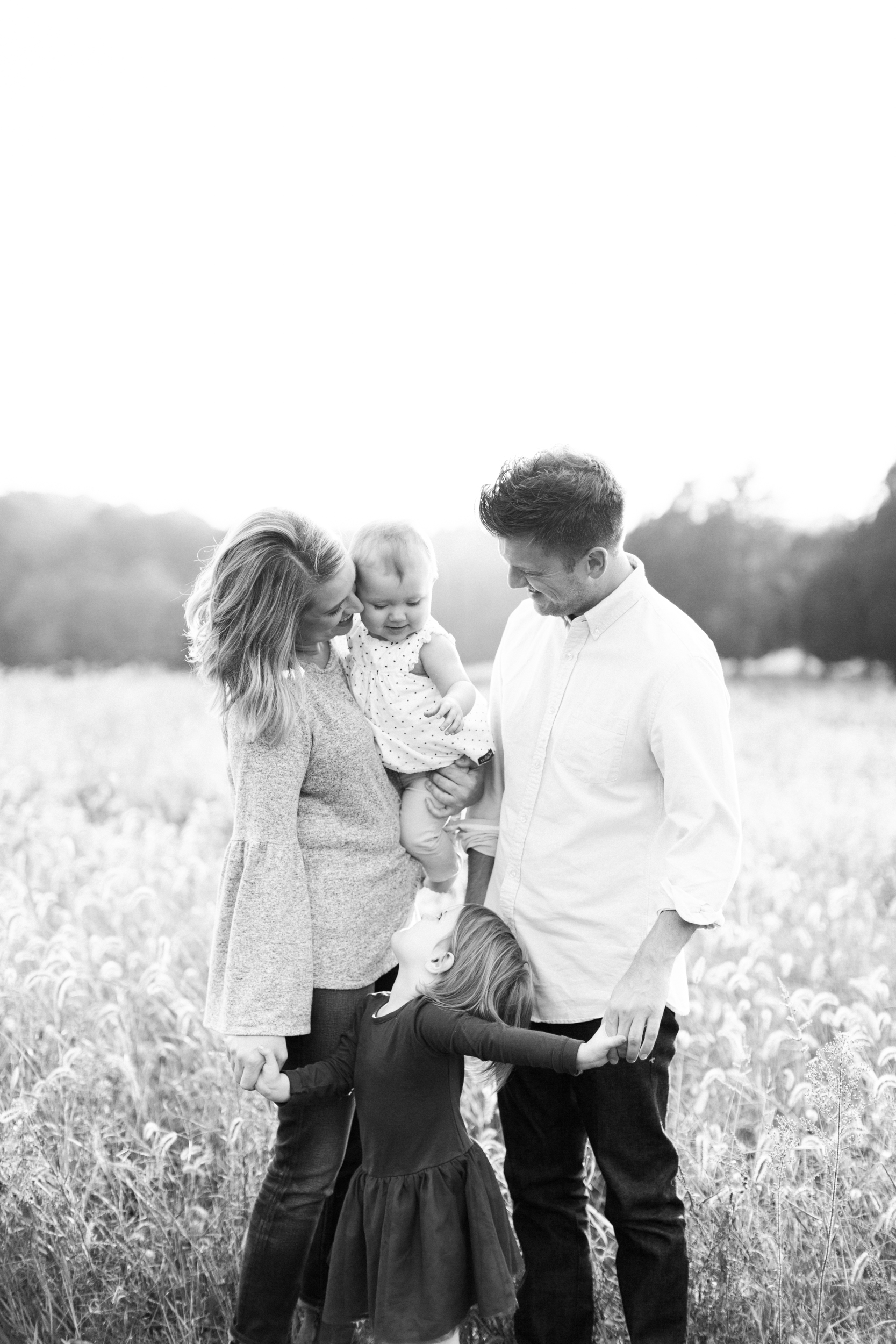 Fall family photo in a field. Photographed by morgan williams photography.