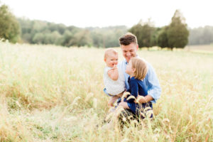 Fall family photo in a field. Photographed by Morgan Williams Photography.