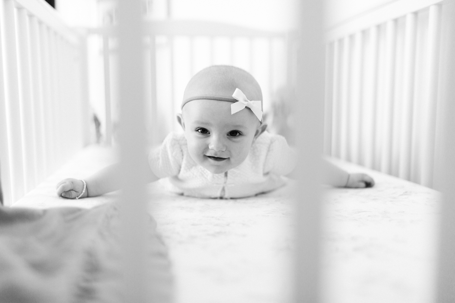 6 month old baby smiling in crib